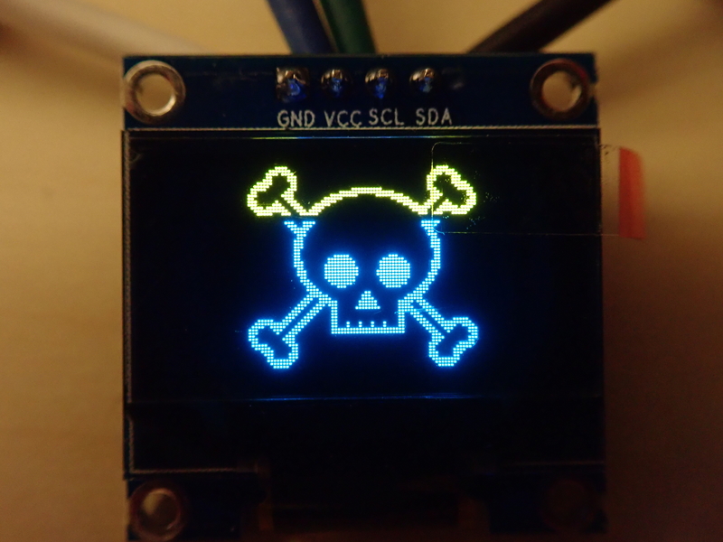 OLED display showing a skull and crossbones